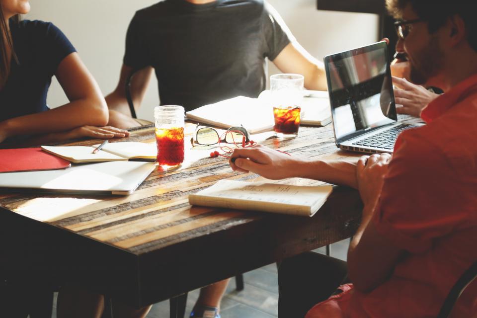 Team working at a table with laptops